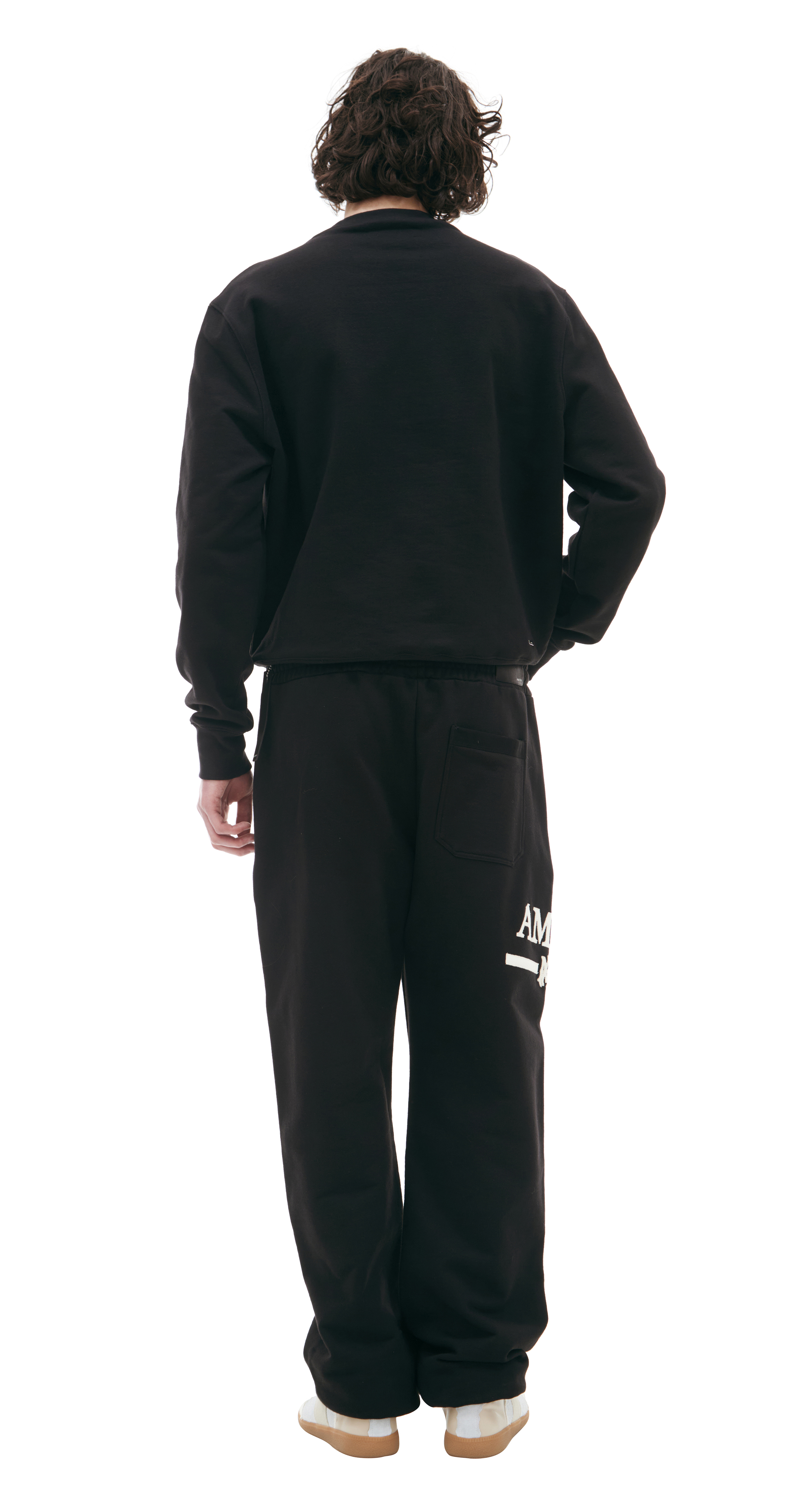 Buy AMIRI men black logo trousers for $502 online on SV77