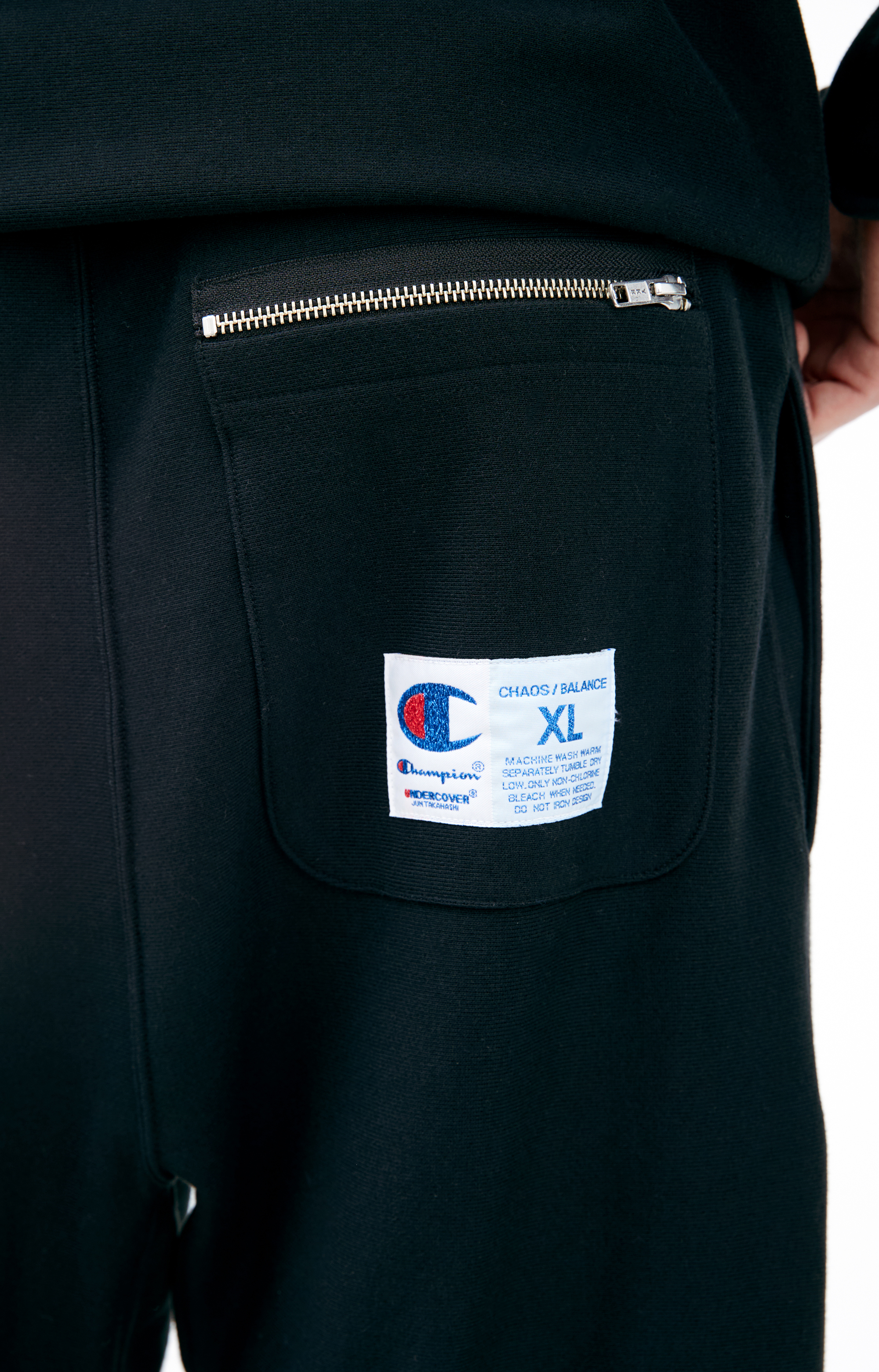Buy Undercover men black x champion trousers for $255 online