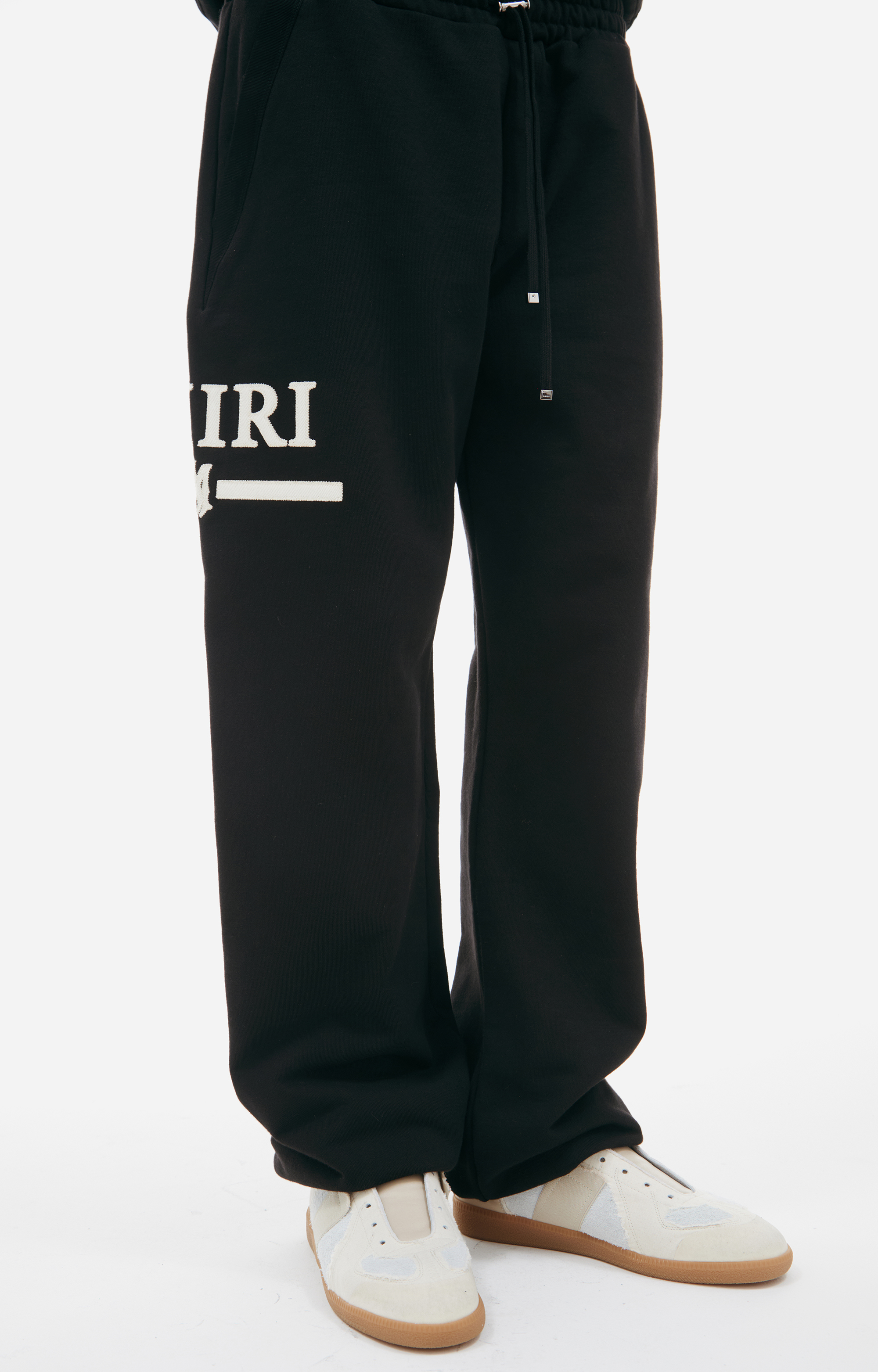 Buy AMIRI men black logo trousers for $502 online on SV77