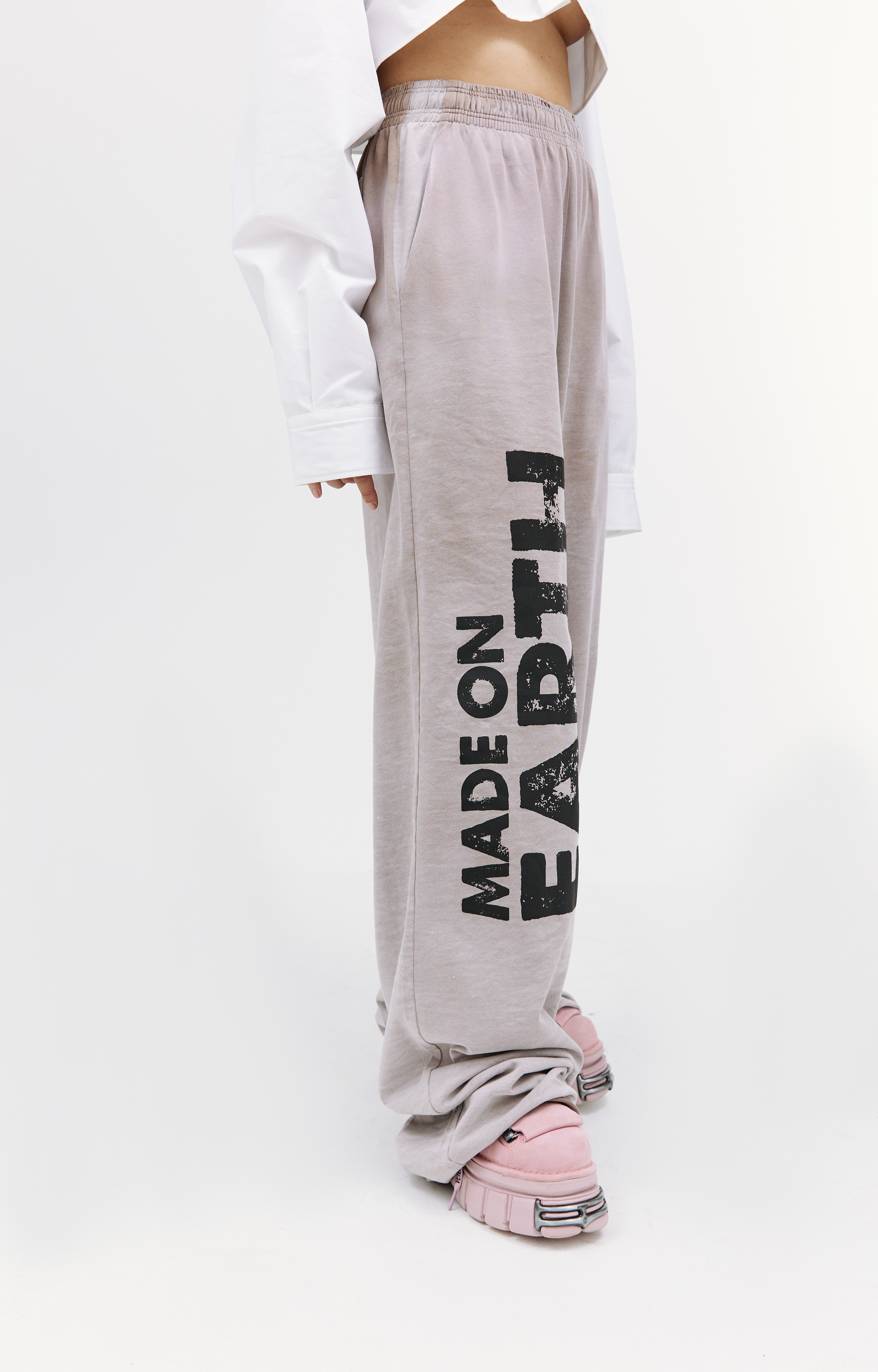 Buy VETEMENTS women beige 'made on earth' sweatpants for $598