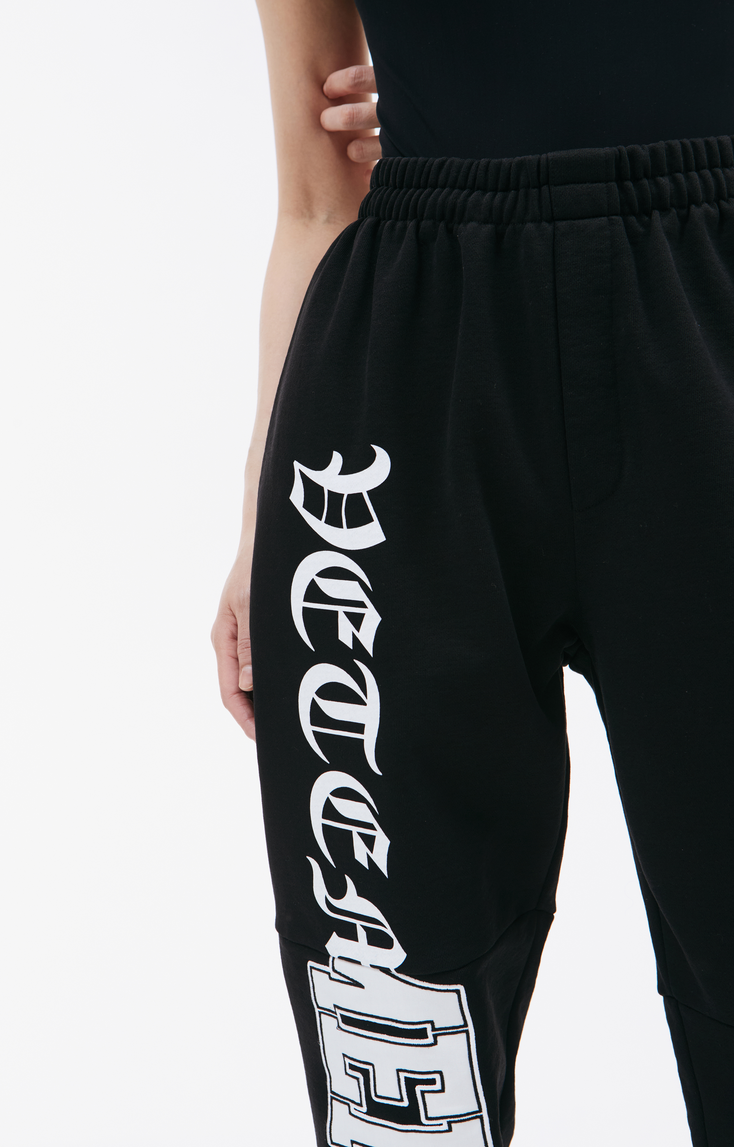 Buy VETEMENTS women black gothic logo sweatpants for $568